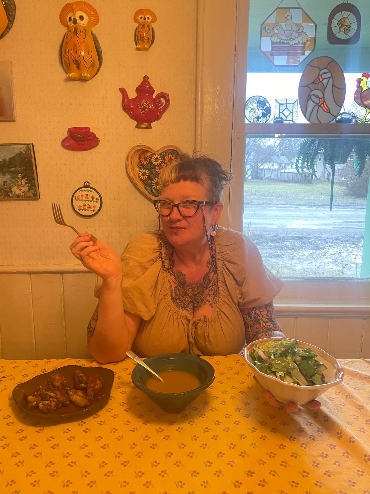 Sara seated at a table with a home-cooked meal